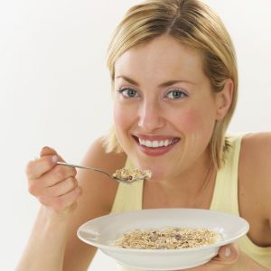 Woman eating cereal for a better smile
