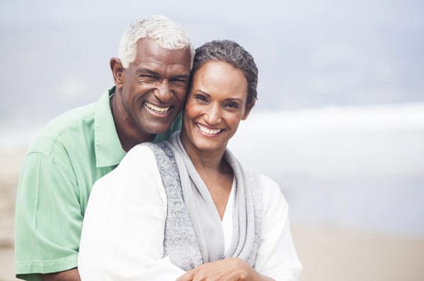 older couple smiling and posing for a photo